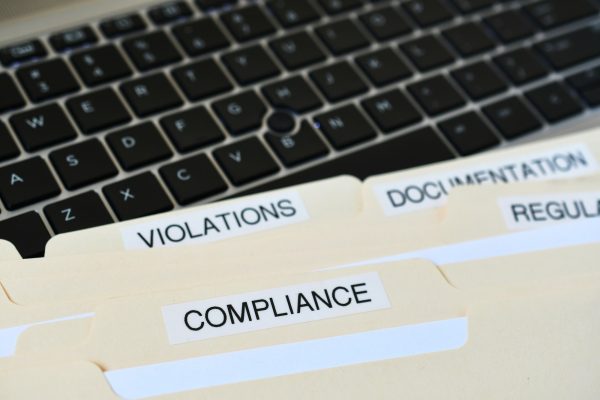 file-folders-with-words-compliance-violations-documentation-on-black-computer-keyboard.jpg file-folders-with-words-compliance-violations-documentation-on-black-computer-keyboard.jpg